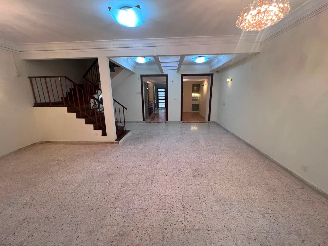 Living features: polished stone flooring, white painted walls, tray ceiling with recessed lighting, chandelier, staircase with wooden railing, large windows, doorway leading to other rooms, multiple ceiling lights; style: modern.